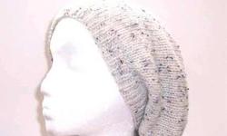 This wool beanie beret is an off winter white tweed with flecks of light, dark blue and brown flecks in the yarn. This knitted slouchy is made with a wool yarn. Completely hand knitted. The measurements are laying flat on a table, across the brim or