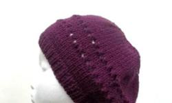 A cute beanie beret hat will keep you warm and cozy this winter. This hand knitted beanie is the color of purple (magenta) and is made with an acrylic and wool blend yarn. 80% acrylic, 20%wool. It has two rows of eyelets. Completely hand knitted. Very