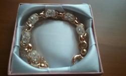 Up for sale new 18k gold plated bracelet with Swarovski Crystals. Comes with the box. Send me an email, if interested.