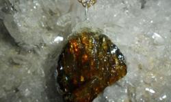 Beautiful Deep Golden Brown Crystal Amber with Crystal on Charm. This is a Beautiful Charm hand Crafted by Paulsgems with a Silver Loop Top. This Charm has Crystal around the edges of the amber. The Crystal Charm would look Beautiful on around your neck