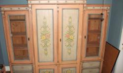 Use in living room or bedroom.
Beautiful hand-painted wardrobe / entertainment center comes with:
*dresser
*adjustable bookshelves
*locking glass doors
*fitted for TV
*shelf for dvd/cable box
*interior space measures 40" across
*hideaway / pocket doors