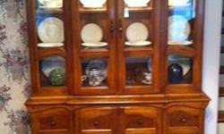 Large Oak China Curio. Glass doors on top, lit from inside to display your valuables. Storage underneath and pullout drawer. A few minor dings and scratches, but an overall lovely piece.
Dimensions: H 76"x W 56" x D 15"
You will need to pick this up in