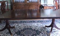 High quality beautiful Mahogany Dining Room table. Excellent Condition! Glossy sheen, brown mahogany attractive flame burl with beautiful grain. Comes with two leaves. Sits 6 to 8 without leaves and 10 to 12 with leaves. 44 width x 120 length with leaves.