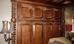 exquisite mansion style bedroom set made of all european hard chestnut wood and italian marble. scrolling and twisting columns stand over 8 and a half feet tall. includes king canopy bed with double mirrored and wood panels connecting to a massive ornate
