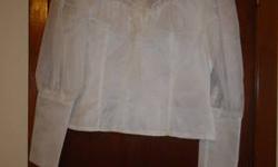 This is a gorgeous white ruffled blouse that would dress up your outfit. It is in perfect condition! Size 13. It buttons in the back. From a smoke free home. Feel free to email me with any questions. Thank you,