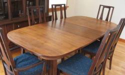 This dining room set from Broyhill's iconic Brasilia line screams mid-century modern. Great design. Notice the arch design on the table base and chair backs. It's beautiful. Made of walnut. Seats 6 or more with the leaf. Well constructed and no structural