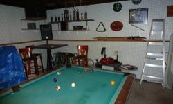 I'm doing this for a friend -- This is a Brunswick Crown II pool table w/ drop pockets. It's been in the family over a dozen years now but the kids are now all grown so it get little use anymore. It is of course a slate bed. It was purchased from the