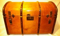 Camelback Trunk with tray.
Beautifully refurbished and lined with old piano music sheets