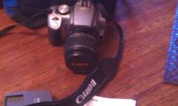 Great camera takes amazing pictures. Cannon rebel xt. Silver body and 18-55mm camera lens. Comes with scan disk, camera strap, rechargable battery, owners manual and camera bag. I do want to point out that the bag is not cannon but samsung. I had it from
