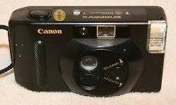 Canon Snappy S
Black, Fully automatic with in built flash, auto film advance, auto focus 35mm camera. Shoulder cord. Takes 2 AAA batteries. Canon lens 35mm 1:4.5.
~ Good clean working condition. I must de- clutter so I have to sell this and so much more!!