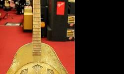Circa 1930 National Triolian Tenor Resonator Guitar Polychrome
An Early 1930?s National Triolian Tenor Resonator Guitar has the pure soul indicative of the old, classic instruments of American Music legend. This Tenor is finished in Polychrome Hawaiian on