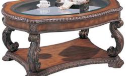 Product description:
This beautiful traditional cocktail table will add a touch of sophistication to your living room. The oval shaped wood framed table top features a carved edge, and an inlaid glass center. Exquisitely hand carved "S" shaped legs