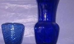 COLOR GLASS VASES: as indicated or all for $40 .
DARK GREEN hand blown squat thick glass vase with white swirls 5" high x 5" diameter $15. GREEN BOTTLE BUD VASE with ten segments 12" high $4. GREEN CUBE 3 1/4" square $4.
DARK BLUE VASE 9 1/2" high $8.