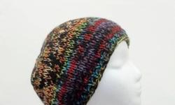 Lots of color is what this hand knitted colorful beanie beret hat has. Red purple,orange,bright green,blue just to name a few. Thick and warm beanie. Knitted with two strands of yarn. Fits men,women and teens. Very stretchy, will fit any head, stretches