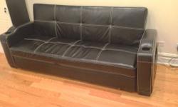 Classy, beautiful black faux leather multi-use sofabed. This very beautiful couch is a find! Real leather, with magazine and cup holders. It can be used as a simple sofa, an accent bed or a flat king-size bed. FULL DISCLOSURE: Couch is nearly perfect,