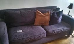 Eggplant-colored sofa, feather-filled back cushions for that oh so comfortable feel and comfort.