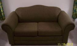 A nice, contemporary olive green couch/love seat is being offered for sale. The couch was made around 2006. This would make a great addition to your family room or living room, just in time for Christmas and the holiday season. This would make a great