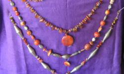 CORAL NECKLACES - any one $20, an two $35. Mix and match with marble and agate necklaces in separate ads.
Elongated silver metal bead elements with jasper, carnelean, coral, crystal, with large 14 sided coral pendant, 24" long
Round and flattened shapes