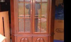 Good condition/dark cherry with 2 glass doors on top, 2 wooden on bottom. Email, call or text 716-679-6379