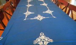 This 32.5 inch by 32.5 inch cross-stitch bridge tablecloth would make a truly unique gift. Retail stores do not sell either bridge tablecloths or cross-stitch tablecloths. This HANDMADE tablecloth from the 1940s or 1950s HAS NEVER BEEN USED and is the