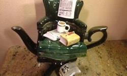 This adorable crossword puzzle chair English teapot is perfect for a crossword puzzle fanatic. It's in perfect, gift-quality condition. It's about 11 inches tall, 12 inches wide and 8 inches deep. The label says Richard Parrington Designs, Whitstable,