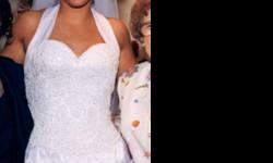 Beautiful custom wedding dress size 10... can be altered to a smaller size. Halter top with hand beaded fitted bodice.
Dress has inverted pleat in the front showing off more hand beading. The train has beautiful detail, also hand beaded.
The money bag and