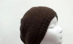 The colors of this hand knitted beanie hat are shades of dark brown and medium brown. Completely hand knitted. Worn by men and women. The beanie beret is made with a soft acrylic yarn. (Note: this yarn manufacturer calls its yarn colors are inspired by
