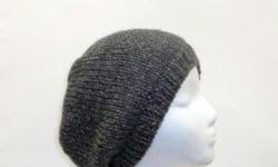 A great dark gray tweed is the color of this knitted beanie hat. This beanie hat is very stretchy, will fit any head, stretches out to 31 inches around. Completely hand knitted. Worn by men and women. The beanie hat is made with a soft acrylic yarn.