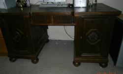 Early American desk and hutch set. Has skeleton key, all glaas in hutch is fine. Every drawer and door works. Not refinished, in original very good condition. Desk is 59"wide X 31"tall X 32" deep. Hutch is 74"tall X 68"wide X 18"deep.