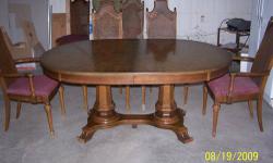 1970 Dining Room Set all wood traditional. Oval table width 45" Length 65" opens to accommodate one or two 18" leaves. Total 101" in length. Easy open because pedestal remains stationary. Glass top to protect table when closed. Beautiful breakfront 74"