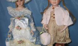 COLLECTOR DOLLS: 16" with porcelain faces and hands. New in boxes. Gorgeously dressed and bejeweled with all kinds of accessories.
The girl (Princess Collection) carries a hatbox bag with her belled doggie on a leash.
The grand lady (Heritage Signature
