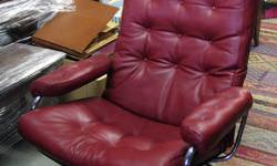 This is a vintage Made in Norway Modern Reclining Chair. The original leather has been redone by a leather professional and is burgandy red in color. The ottoman has also been re-upholstered to match. Some light corrosion on the chrome tube bases makes