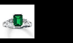 This is a gorgeous lab-created Emerald Ring with diamond accents on each side that add sparkle. It has been worn a very short time and looks brand new. I purchased the extended service plan and lifetime diamond and gemstone guarantee when I bought the