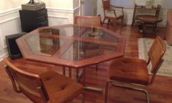 Oak and glass table with 4 chairs. 48" octagon design. Many more pieces of furniture at estate sale held by appointment. Oak coffee table, inlaid wood end table with drawer makes a good TV stand, white Formica dresser, 4 custom, Formica desks and many