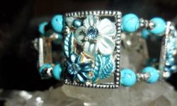 Beautiful handmade Flower design Bracelet with Blue Swarovski Crystal, Turquoise Beads, Silver insert and Silver loop lock. One of a kind Bracelet and Perfect with Perfection. In real time the Bracelet is just Gorgeous. Beautifully hand crafted by