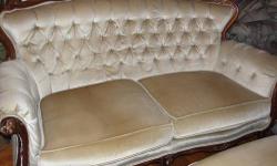 This beige colored couch and loveseat are in fair condition. Though there is wear in this furniture it does not detract from the overall softness of the material and the rich feeling of the design.