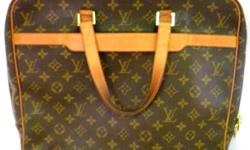 Up for sale an authentic Louis Vuitton soft attachÃ© or briefcase in treated canvas with buff leather trim in the signature LV monogram print. The piece has 2 leather handles. The interior has a key ring, one zipper compartment, two pockets and one cell