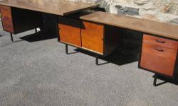 This classic mid-century desk is in the style of George Nelson for Herman Miller. Made by Robert John, "Makers of Contemporary Furniture". Great style and function. In good condition. Features 5 drawers and a huge cabinet with sliding doors. Uniquely