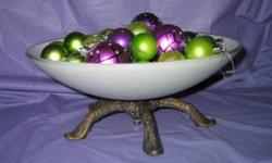 BOWL SERVER for fruit, flower arrangements or decorative uses. Milk glass bowl 13" diameter stands 5" high on sturdy gilded metal base with five feet. $9. Shown in photo as table decoration with colorful holiday tree balls.
Please click on "view all ads"