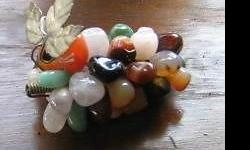 CLUSTER OF SEMI PRECIOUS STONE GRAPES. On silver colored stem with leaf. Rose quartz. agate. black onyx. aventurine. amethyst. carnelian. crystal. Probably 50 or more stones tightly wound. $25
Please click "VIEW ALL ADS" on the right to see other items I