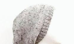 An interesting texture in this gray oversized beanie hat, it is gray with tiny flecks of dark brown and light brown worked into the yarn which gives it a marble effect. The oversized beanie is completely hand knitted. Suitable for men, women and teens.