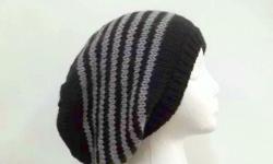 The colors of thisoversized beanie hat are black with light grey stripes. Hand knitted. Suitable for men or women. This oversized beanie hat, slouchy beanie is great for cold winter days. This slouch hat is made acrylic yarns. The slouch hat stretches out
