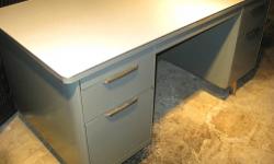 This metal tanker desk has a very sleek design. The integrated drawer pulls are very mid-century modern, and the linen pattern top is rare.
Cash or PayPal accepted. Local delivery available for a fee.