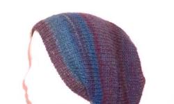 The colors in this hand knitted beanie beret are teal, blue, lavender, purple, mauve, turquoise, and a few more. This slouch hat is very colorful. Stretchy, will fit any head, stretches out to 31 inches around. The yarn is 53% wool and 47% acrylic. Very