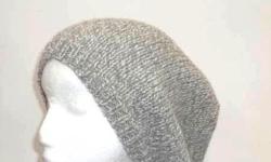 The colors in this hand knit slouch hat are medium gray and white. The look of a tweed. A warm comfy hat for winter days. Worn by men and women. This wool beanie beret is knitted with a soft pure wool yarn. The wool beret is a medium thickness, very