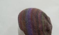 The colors in this hand knitted beanie are beautiful purple,lavender, rust, several shades of green, dark red, golden brown, a large variety of colors. Very colorful. Stretchy, will fit any head, stretches out to 31 inches around.
Available at: