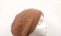 The color of this beret is camel brown (a medium tan). This hat is made with a soft 100% merino wool. It is a medium thickness. Very stretchy, will fit any head, will stretch out to 31 inches around. Completely hand knitted. Three rows of eyelets are
