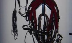 Black leather gentlemen's one horse harness with solid brass attachements in excellent condition with maroon wool pads. Also included is the bridle and bit with leather reins. Purchaser responsible for all shipping costs.