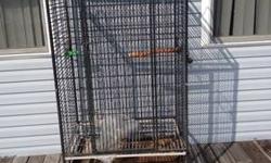 Large cage over 5 ft tall. originally $1000. Good shape, some coating coming off and one bar bent at door but solid cage for large birds such as mccaws and cockatoos. Multi doors for food and water dishes, top braces and play rack. Pick up for price, or