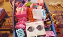 This is a huge lot of Barbie dolls and more! This lot includes 20+ barbies, lots of furniture, 1 big house, 2 small houses, clothes, 1 changing room, cars, and plastic animals. This is in mint condition and gently used. This lot comes from a smoke-free